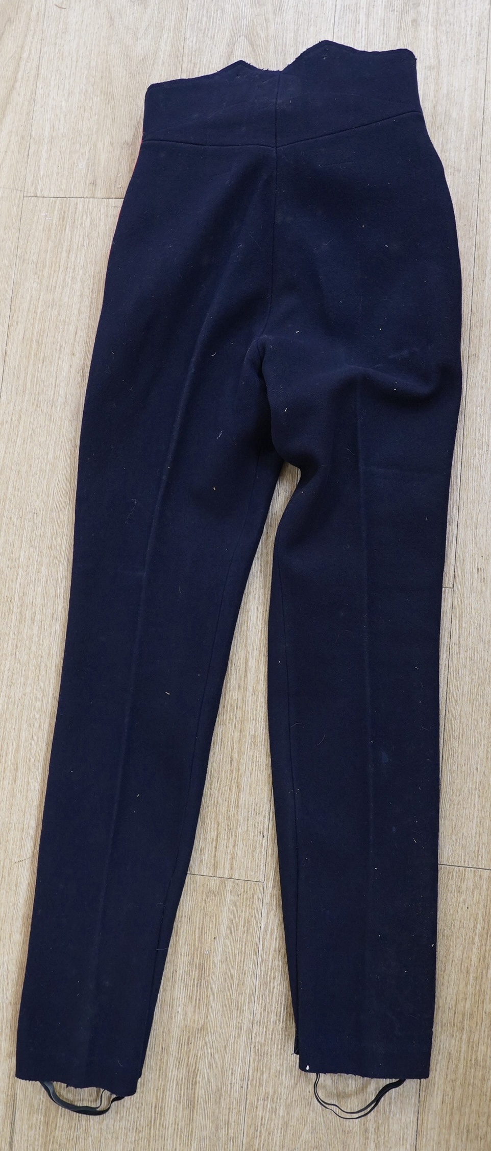 A Sixth Light Infantry officer’s uniform with epaulettes, comprising jacket and dress trousers. Condition - poor to fair, some staining and moth damage, etc.